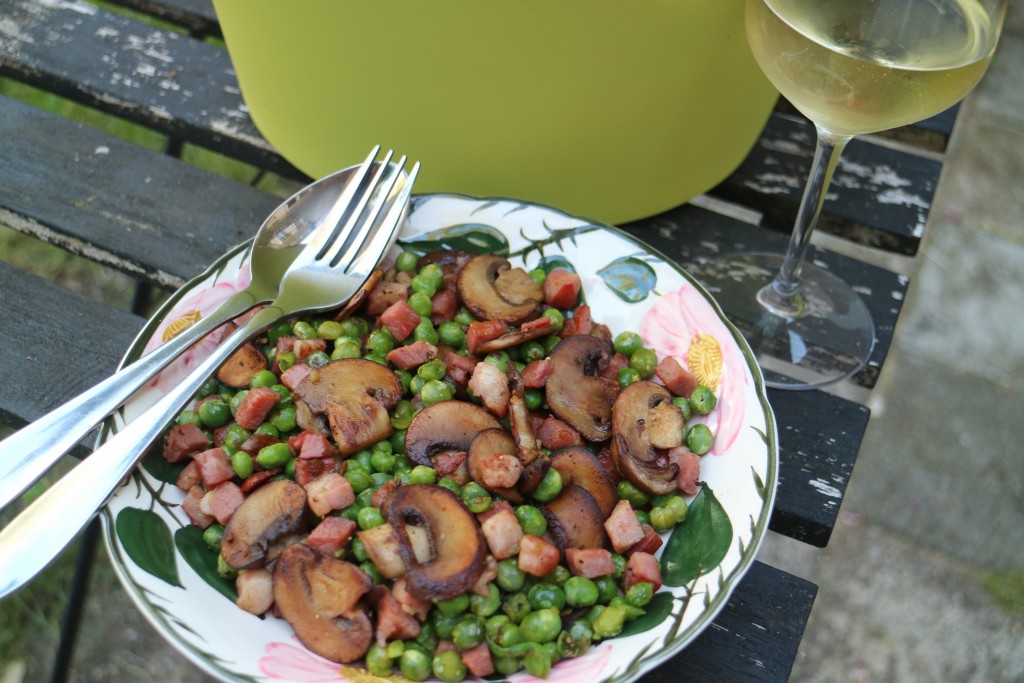 Dinner for one; mushrooms, green garden peas and speck (bacon)
